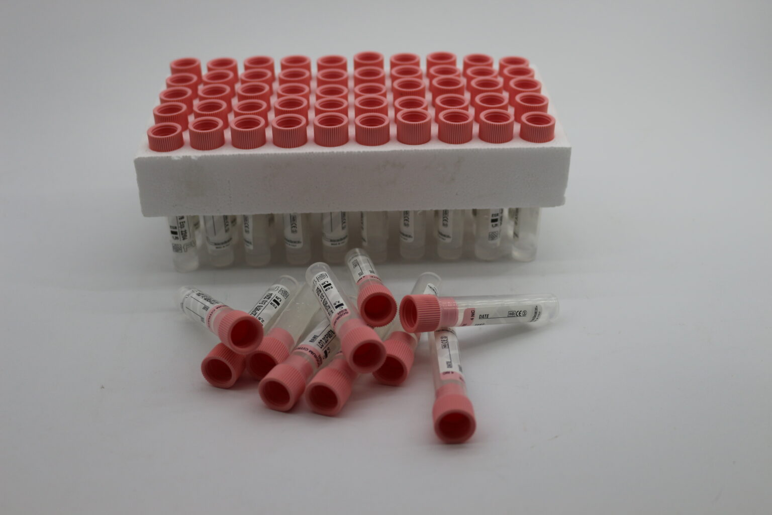 Pink Lab Tube The image displays several vacuum blood collection tubes with pink or ...